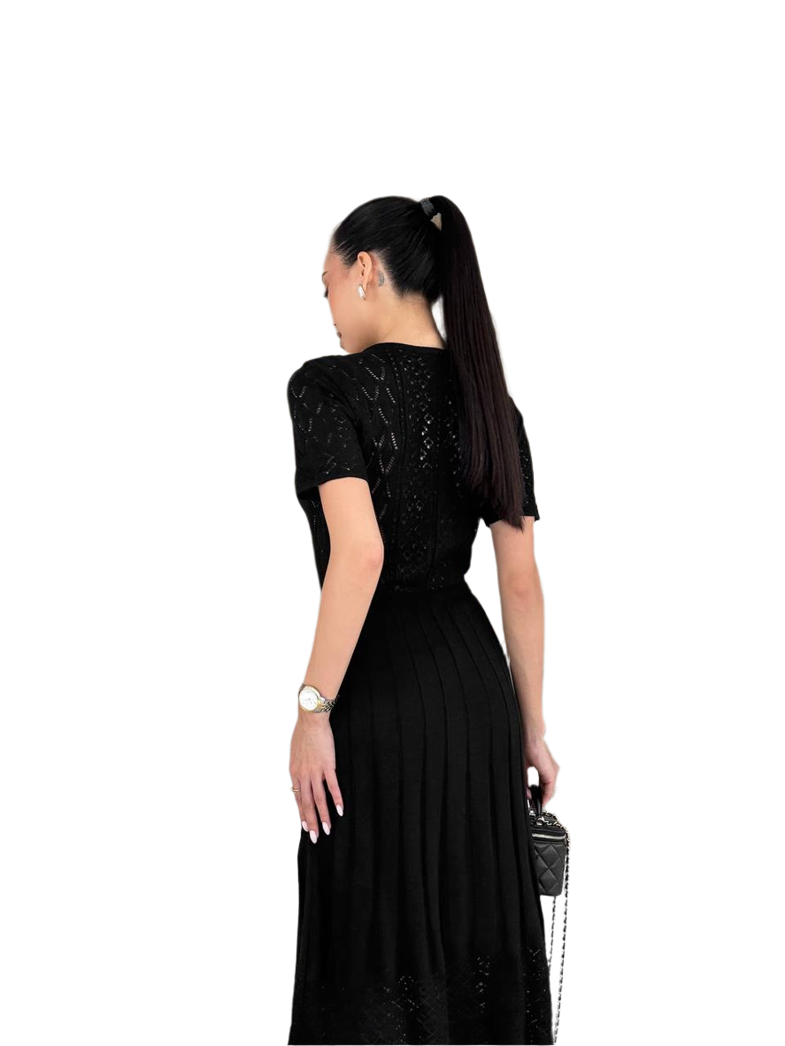 Woman wearing a black dress with a white background
