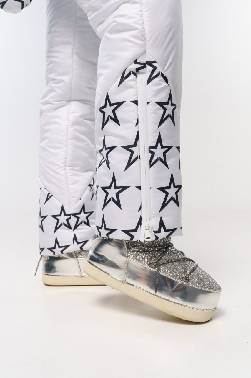 White puffer pants with star patterns and silver glittery boots on a white background