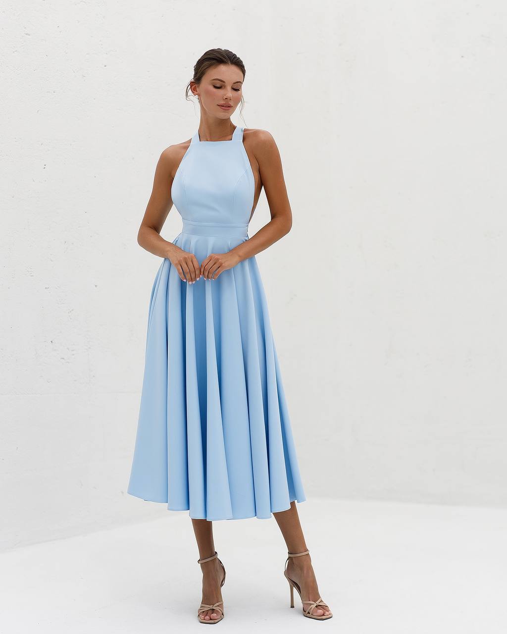 Woman wearing a light blue dress on a white background