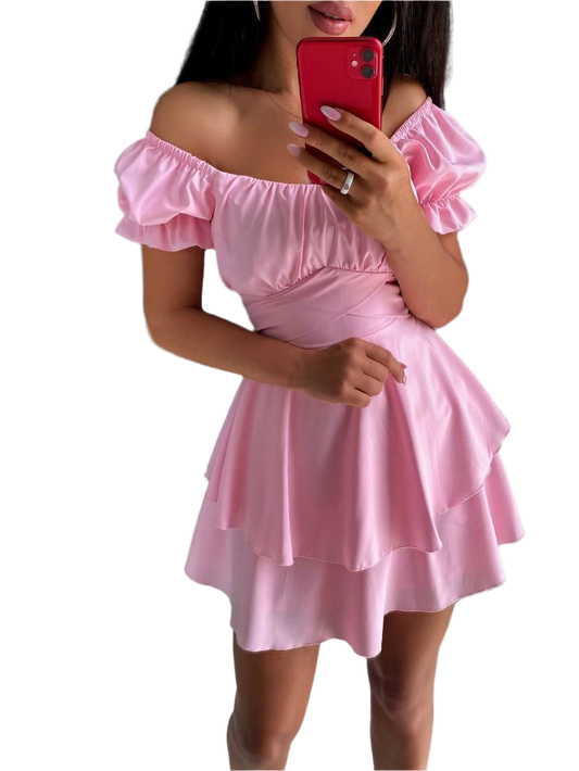 Pink off-shoulder dress worn by a person on a white background