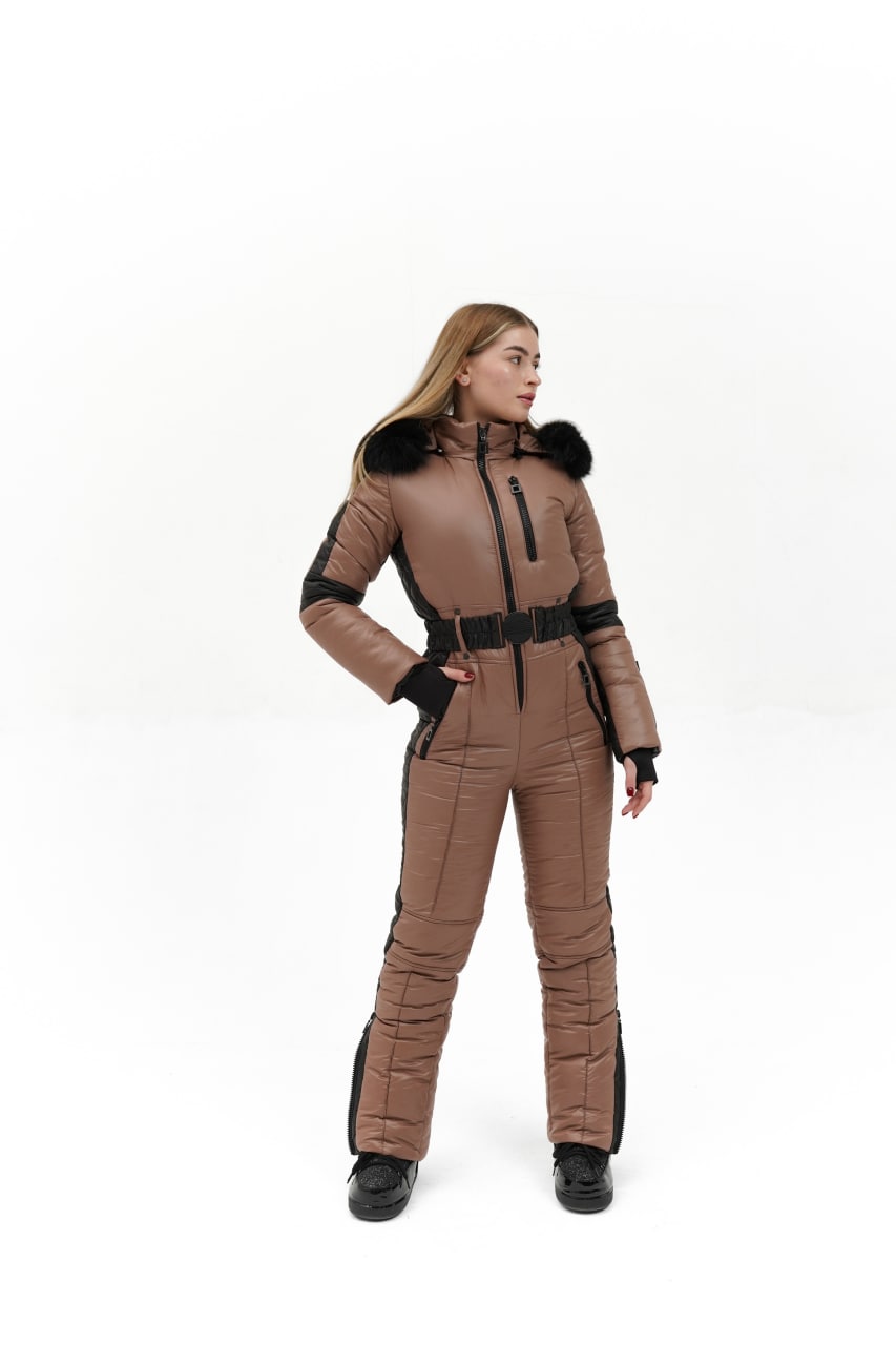 Person wearing a brown snowsuit with black accents on a white background