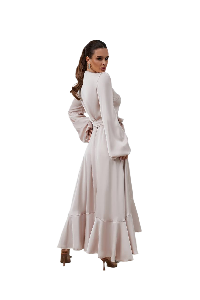 Woman wearing a long, light-colored dress on a white background