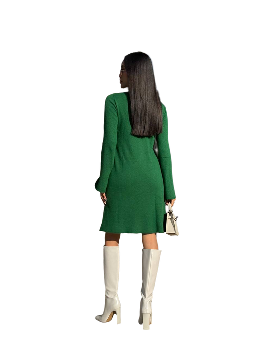 Woman wearing a green dress and white knee-high boots on a white background