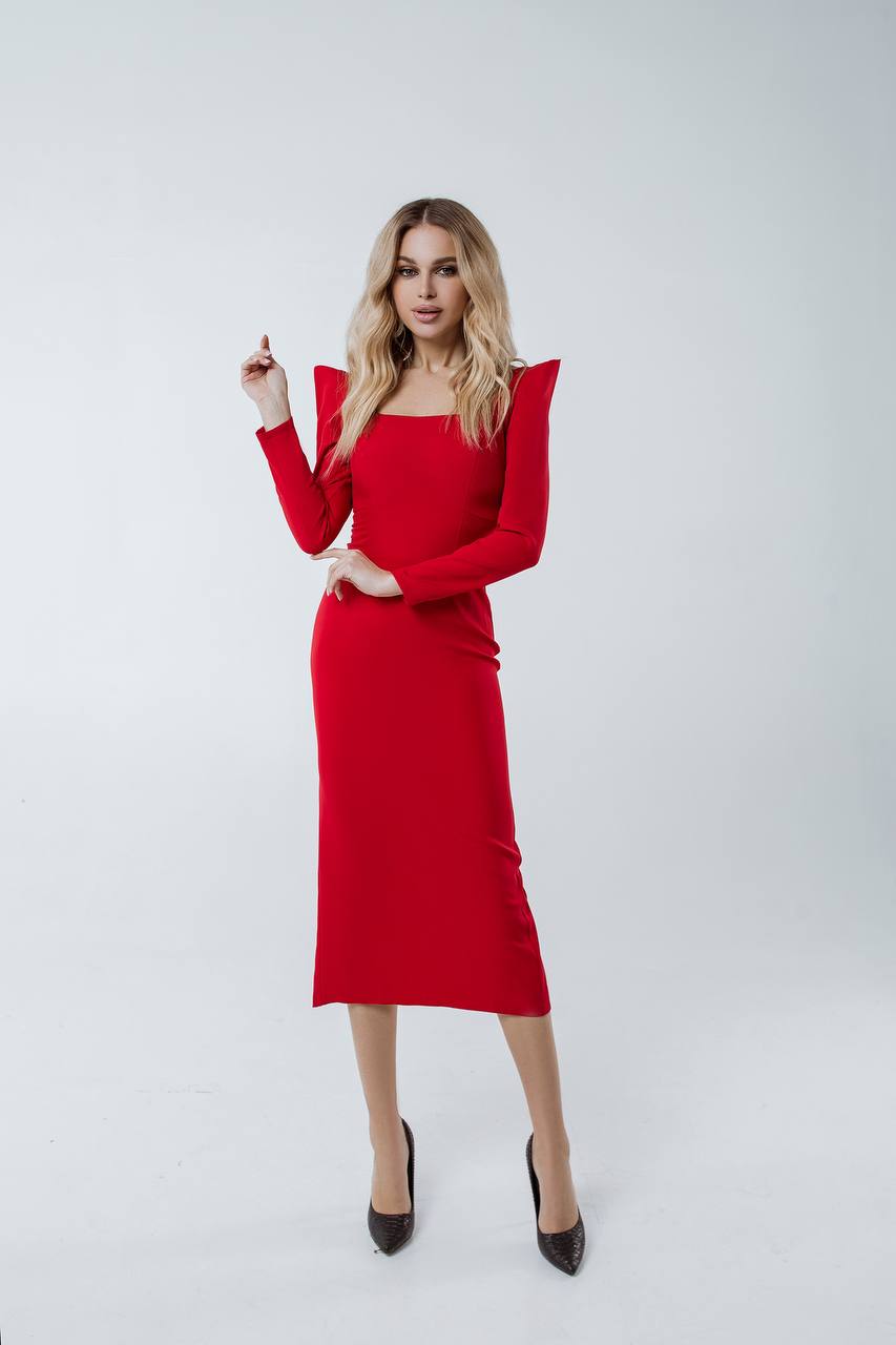 Woman wearing a red dress with long sleeves on a white background