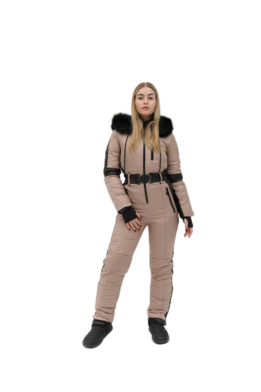 Person wearing a beige snowsuit with black accents on a white background