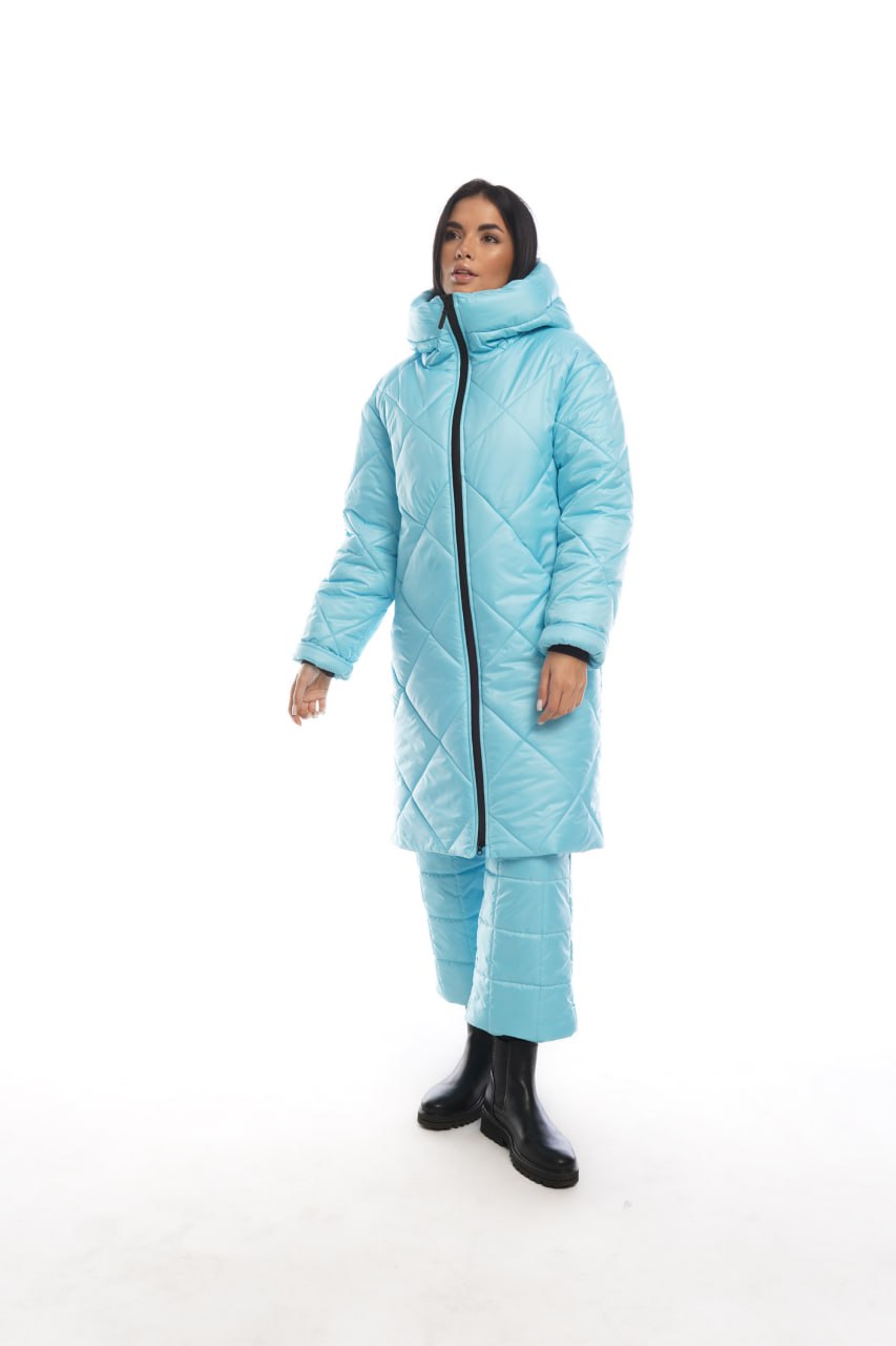 Person wearing a light blue puffer suit on a white background