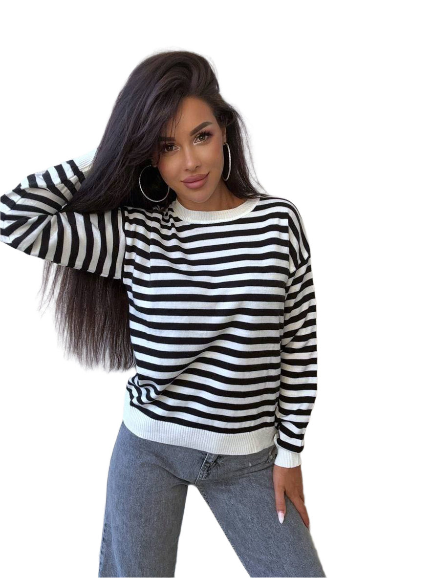 Woman wearing a black and white striped sweater with a plain background