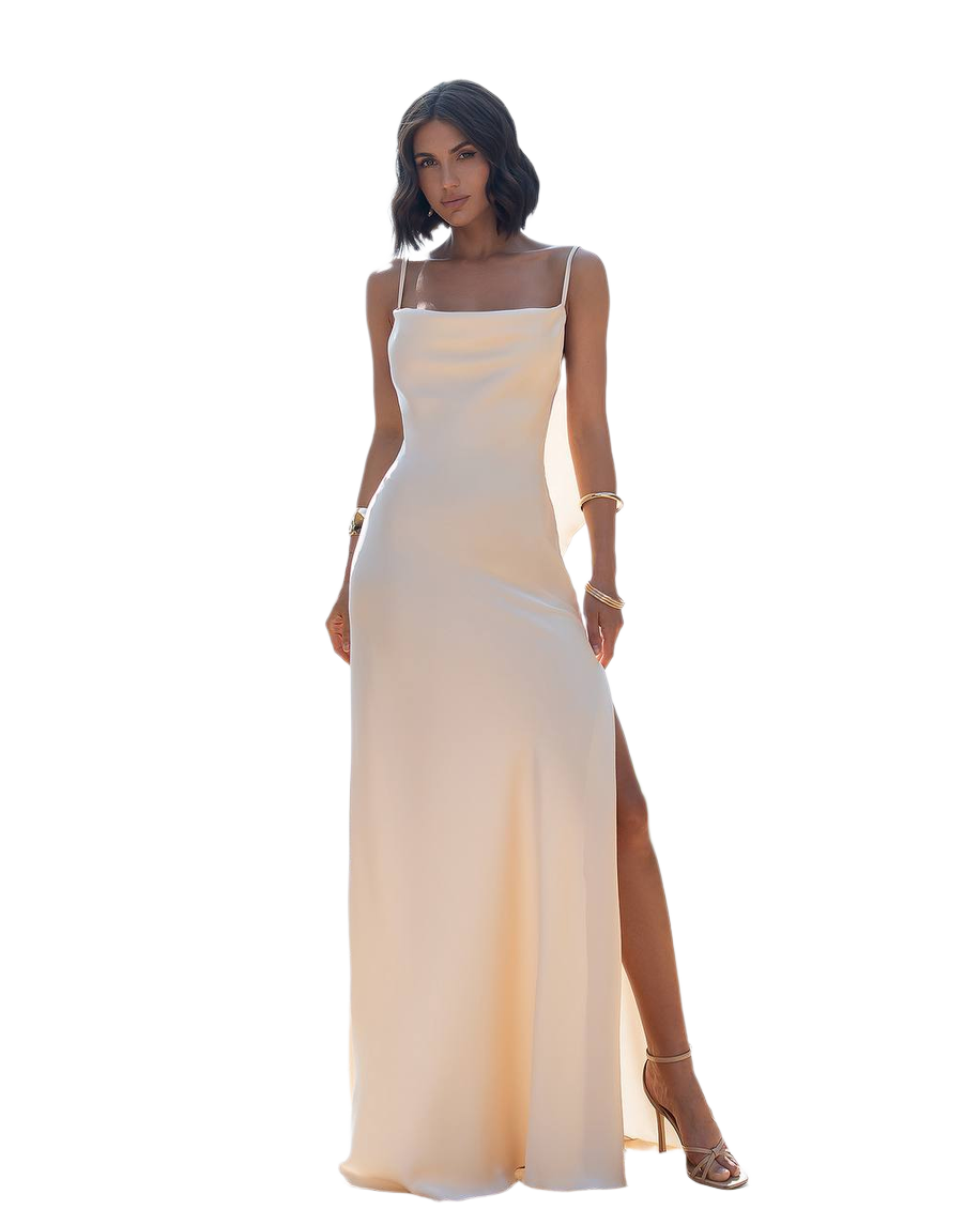 Woman wearing a beige evening gown with a slit on a white background