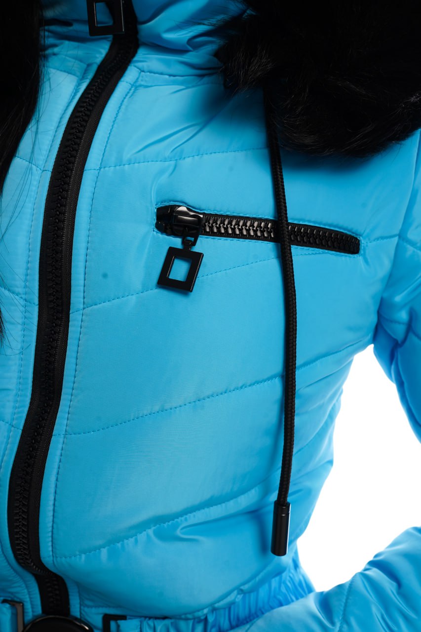 Close-up of a blue jacket with a black zipper on a white background