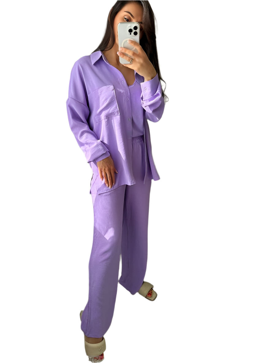 Person wearing a lavender pajama set taking a mirror selfie.