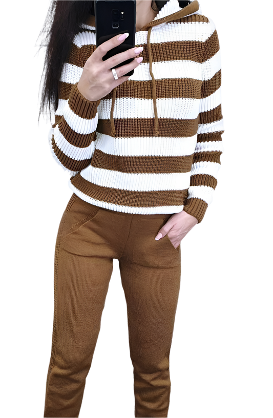 Person wearing a brown and white striped sweater with brown pants on a white background