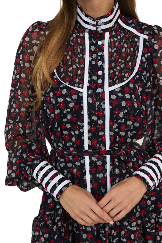 Woman wearing a floral dress with black, red, and white pattern