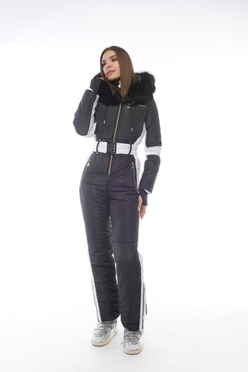 Person wearing a gray and black snowsuit with white accents on a white background