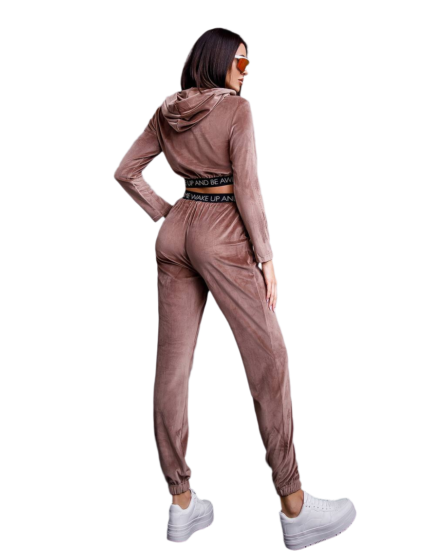 Woman wearing a brown tracksuit with a hood on a white background