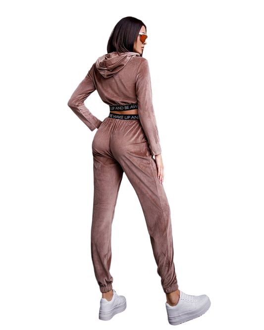 Woman wearing a brown tracksuit with a hood on a white background