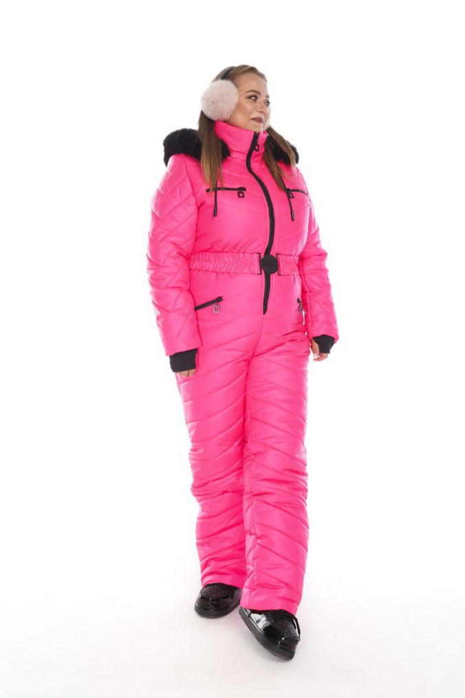Person wearing a bright pink snowsuit with black boots on a white background