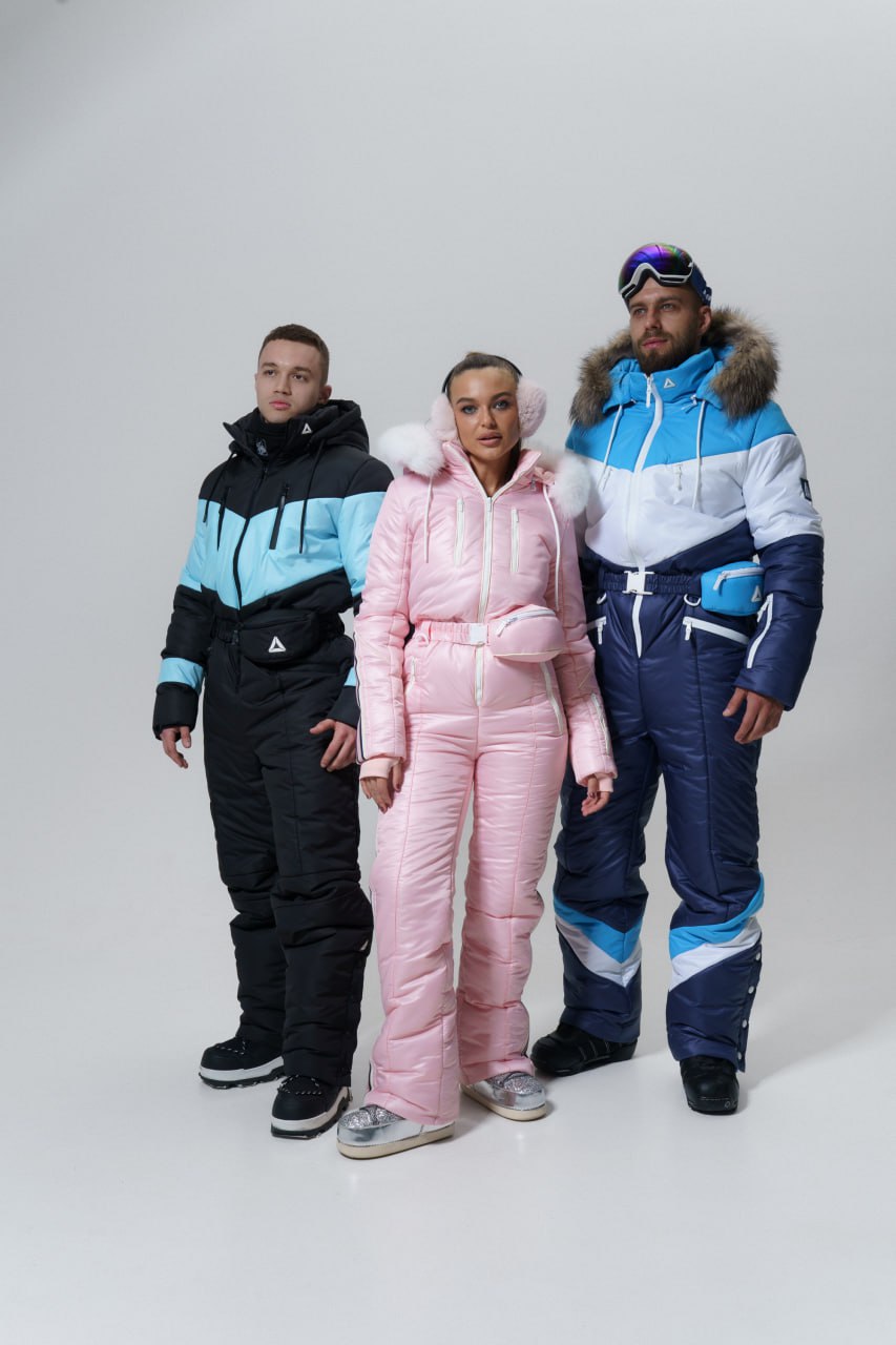 Three people wearing colorful winter suits on a white background