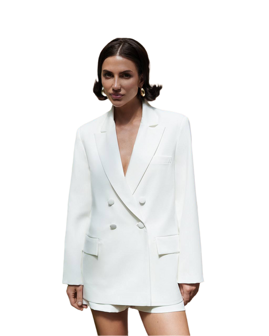 Woman wearing a white blazer and shorts set on a white background