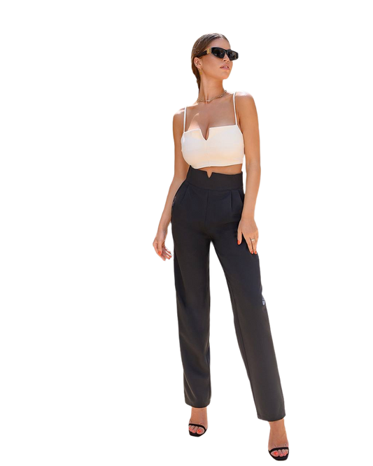 Woman wearing a white top and black pants on a white background