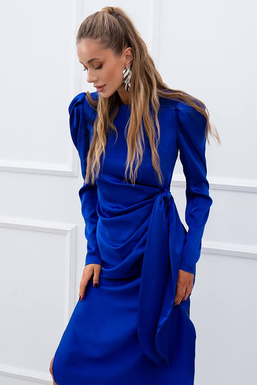 Woman wearing a blue dress against a white background
