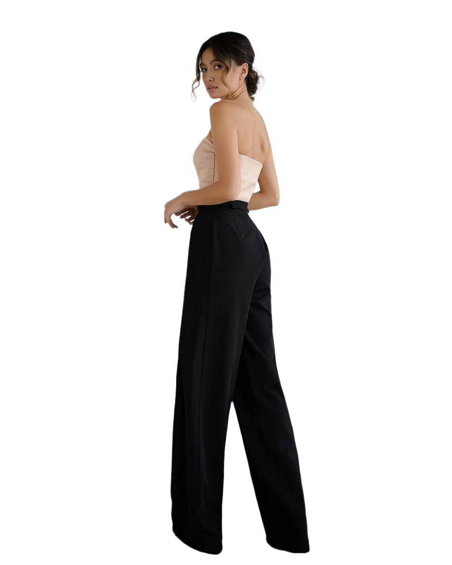 Woman wearing a strapless top and black pants on a white background