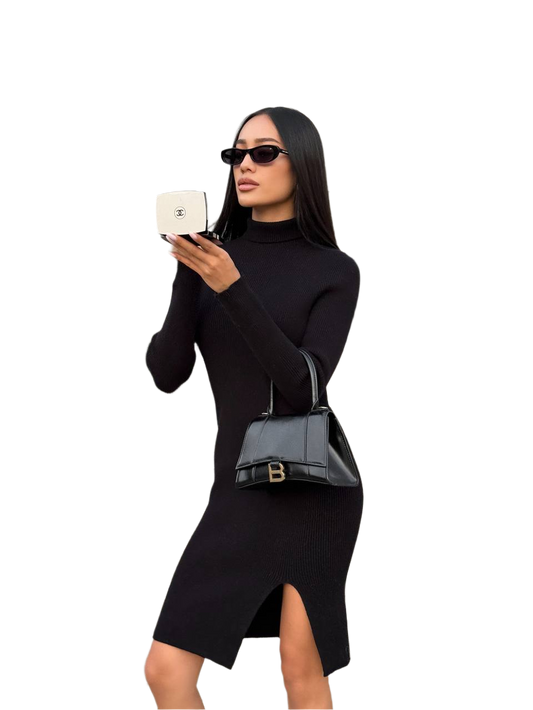 Woman in a black dress holding a black handbag and white box on a white background