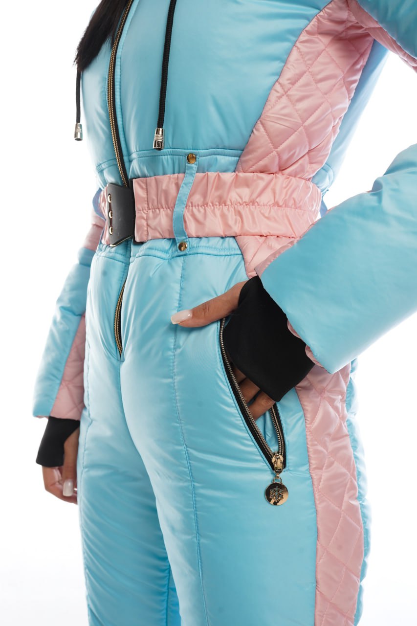 Light blue and pink quilted jumpsuit with black accents on a white background