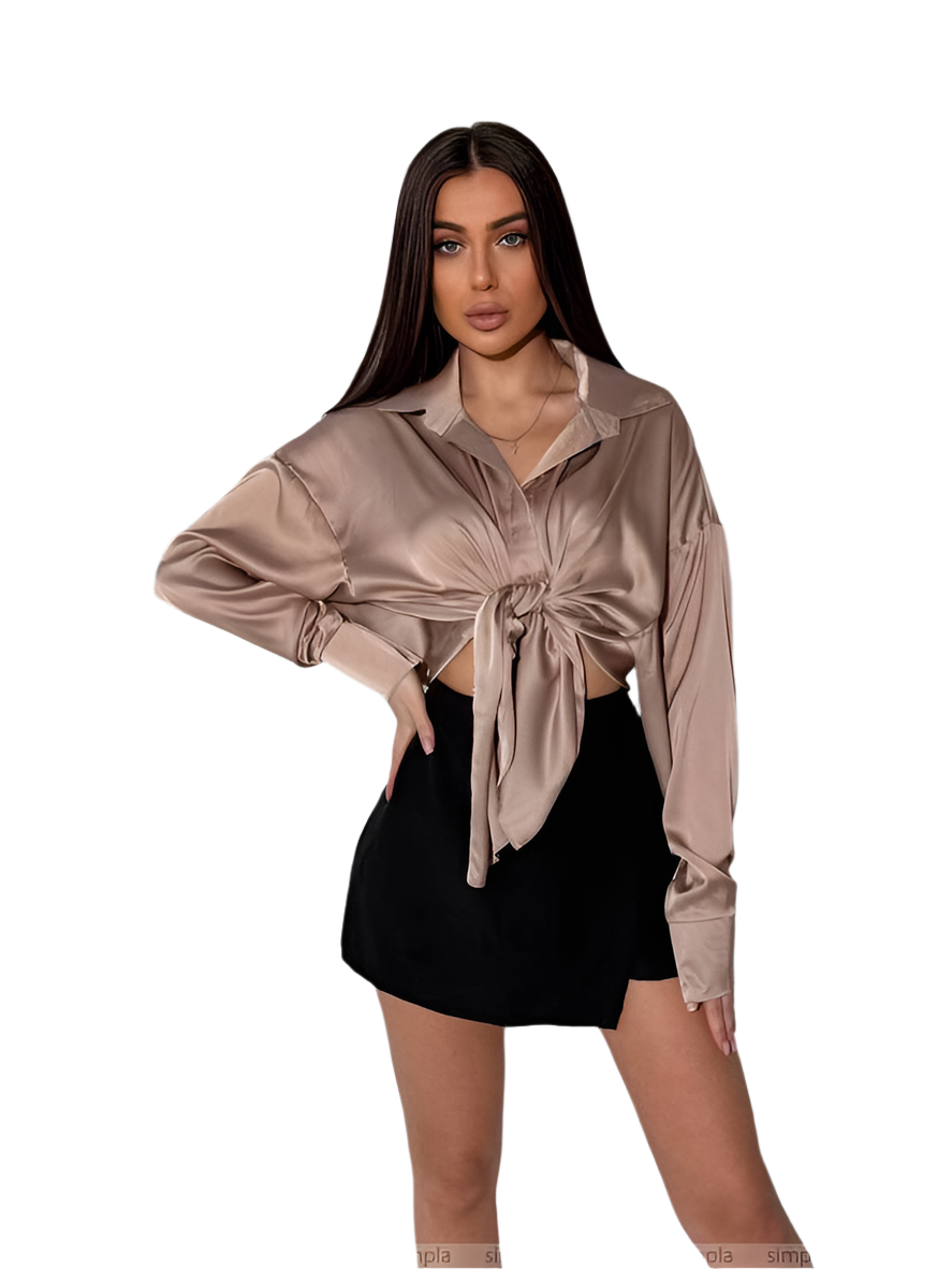 Woman wearing a beige satin shirt with a tie front design on a white background