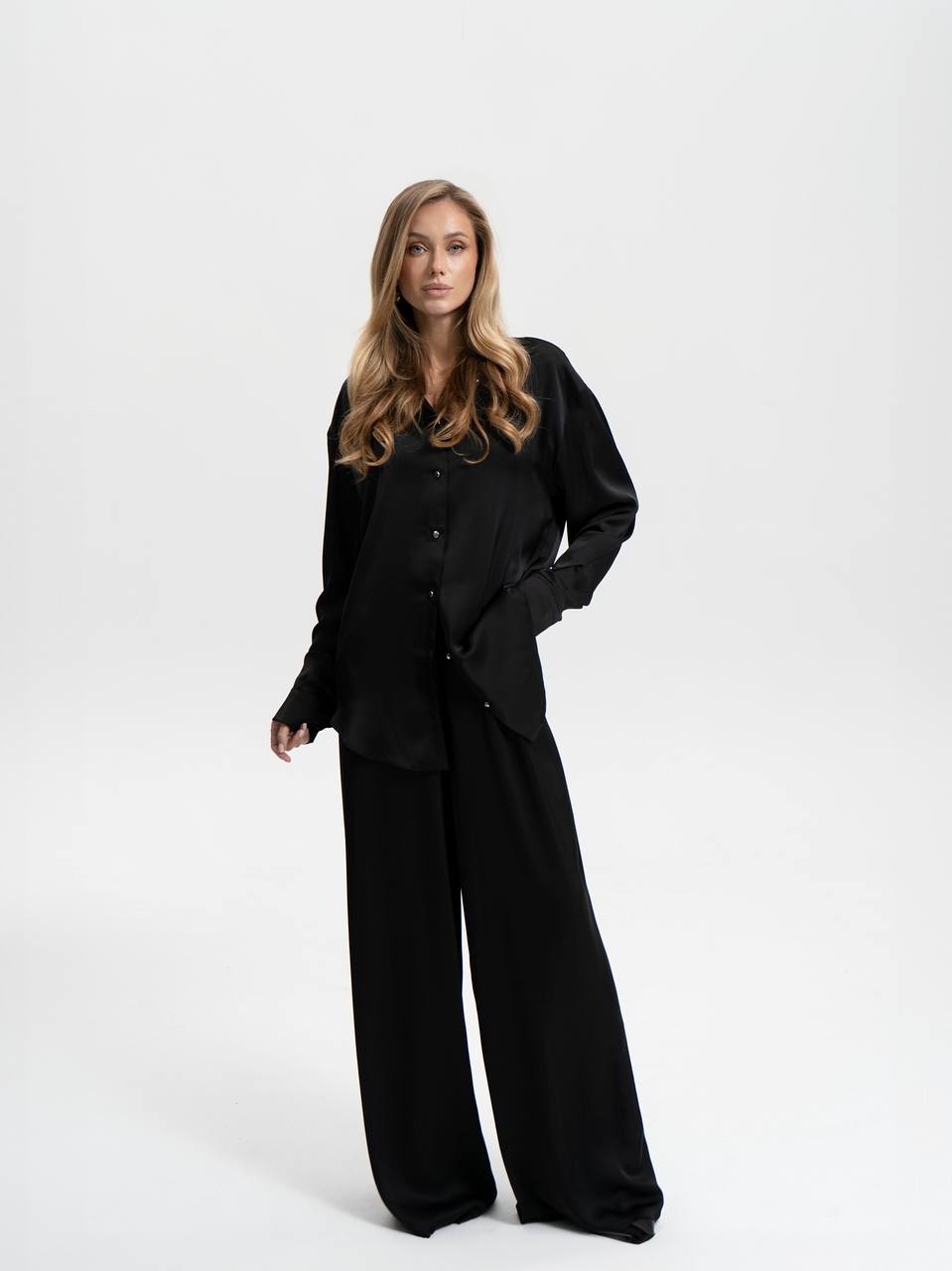 Woman wearing a black outfit on a white background