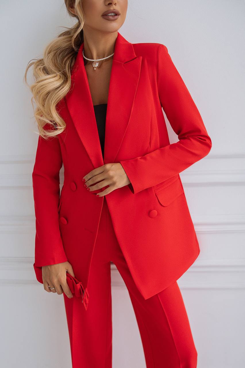 Person wearing a red suit against a white background
