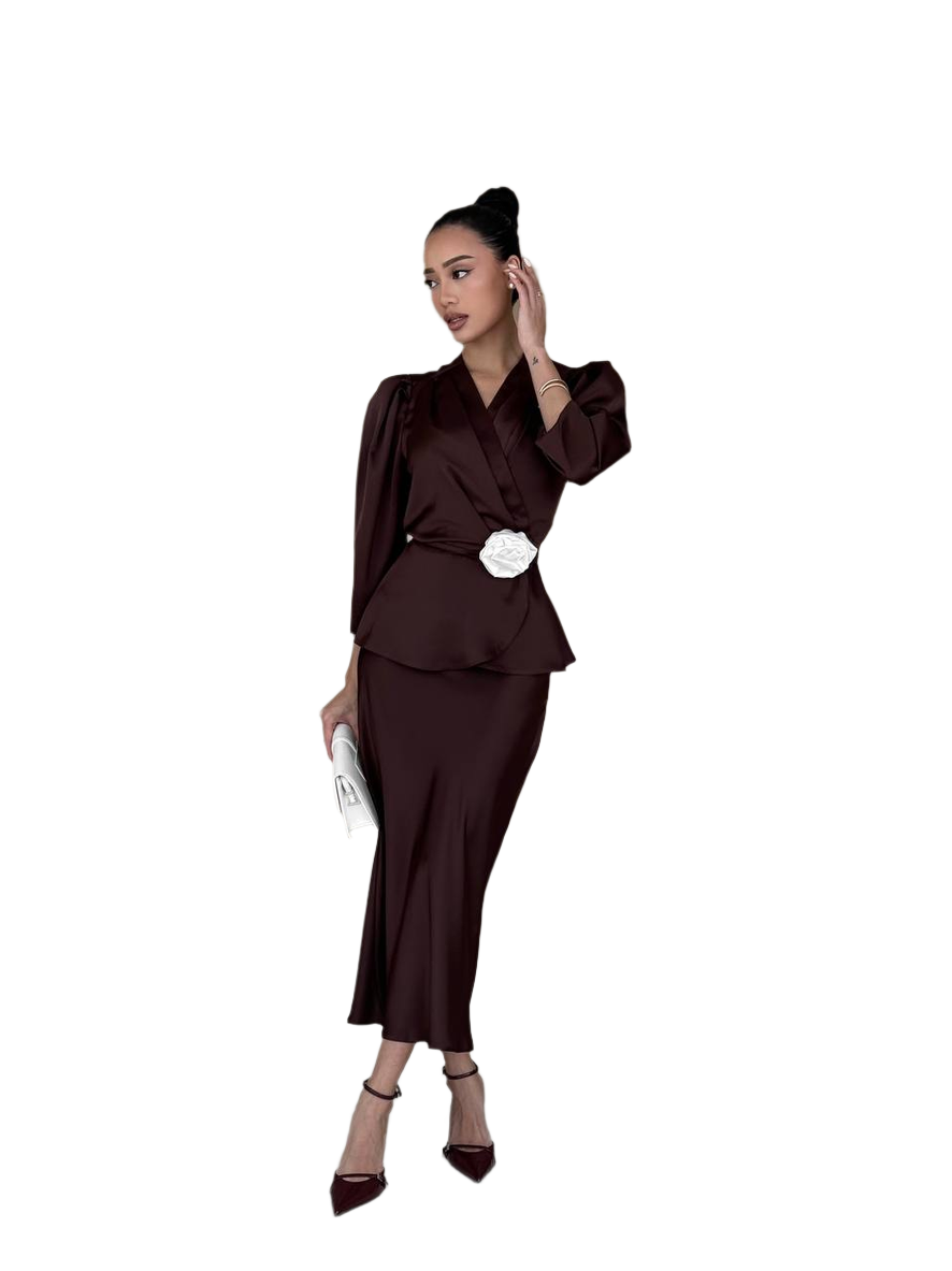 Woman wearing a brown outfit with a white belt on a white background