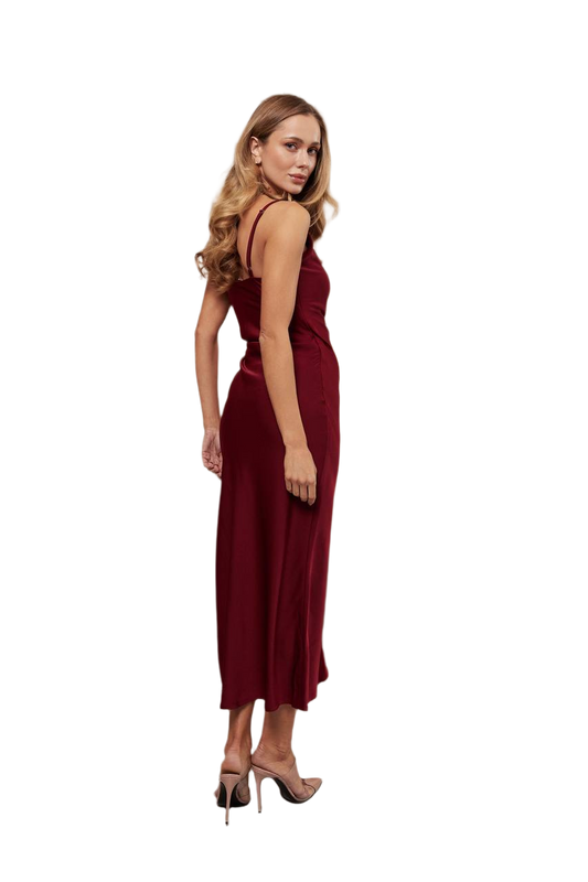 Woman wearing a burgundy dress on a white background
