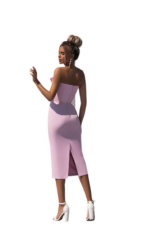 Woman wearing a strapless pink dress with a white background