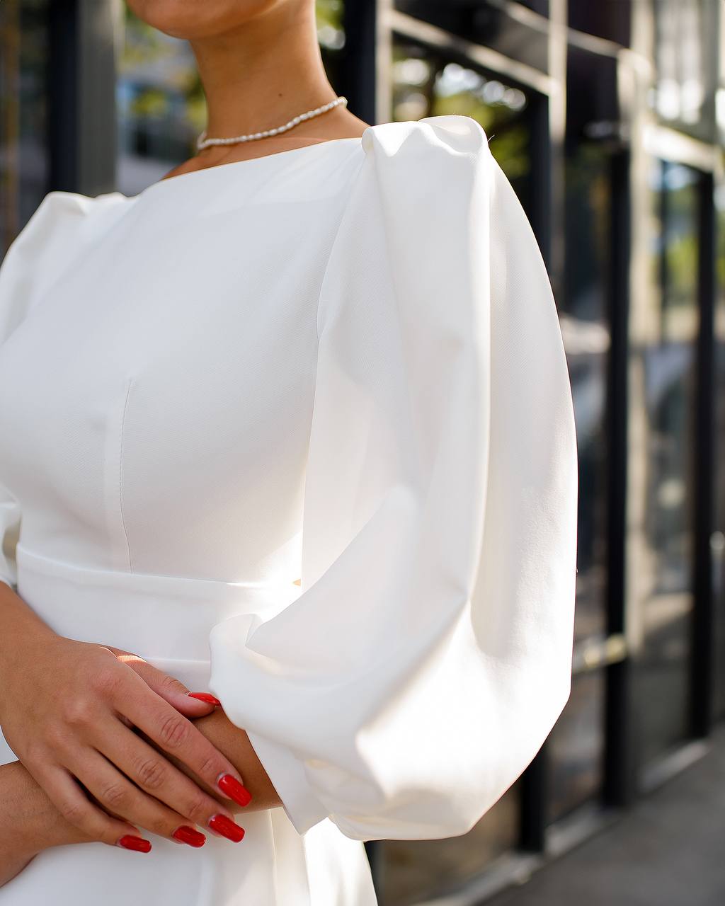 White off-shoulder dress with a blurred background