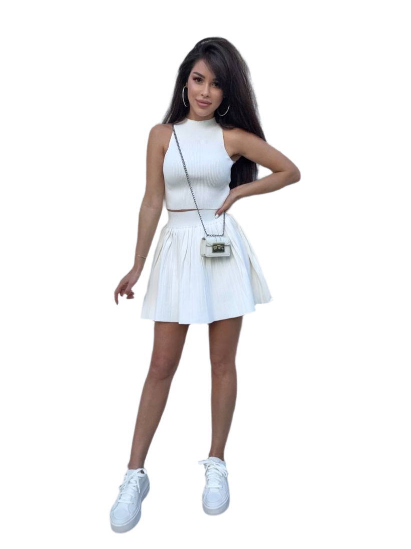 Woman wearing a white dress with a matching handbag on a white background