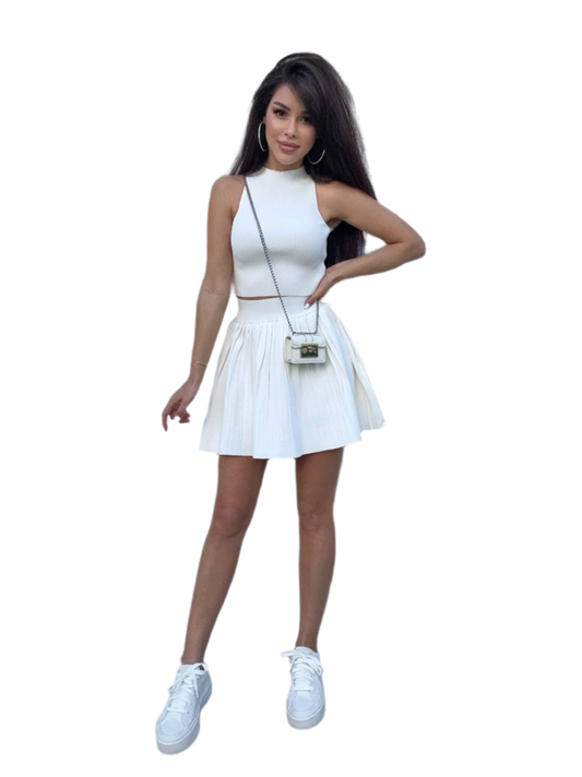Woman wearing a white dress with a matching handbag on a white background