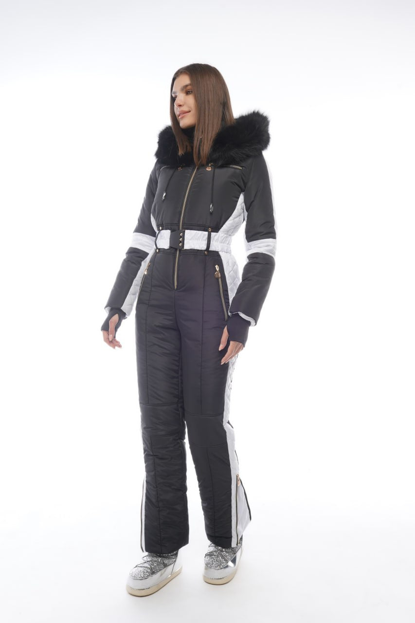 Person wearing a gray and black ski suit with white accents on a white background