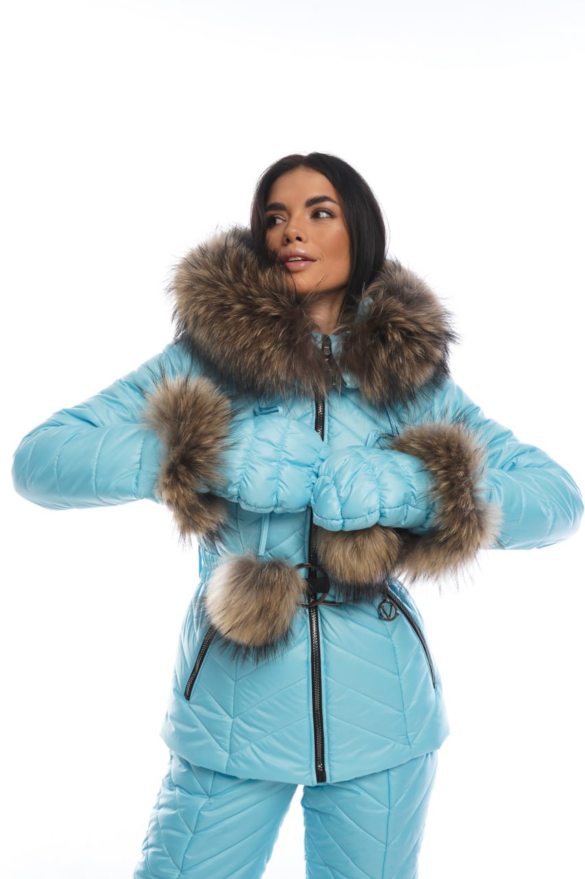 Person wearing a light blue winter coat with fur trim on a white background