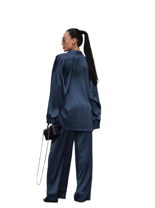 Person wearing a blue satin outfit with a white background