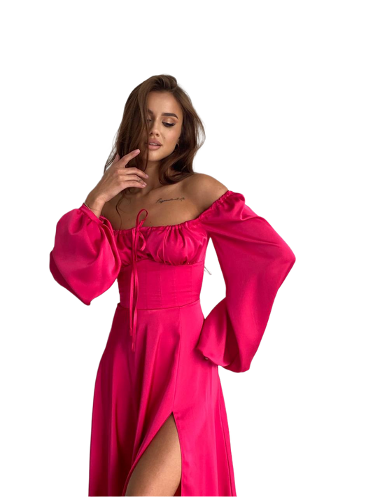 Woman wearing a bright pink off-shoulder dress with long sleeves on a white background