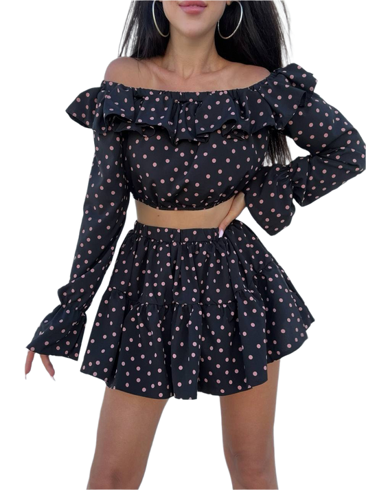 Black polka dot off-shoulder top and skirt set on a white background