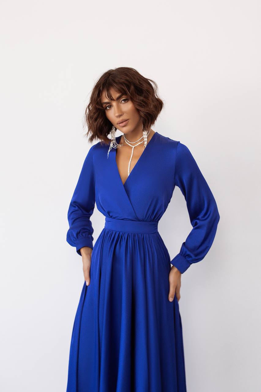 Woman wearing a blue dress against a white background
