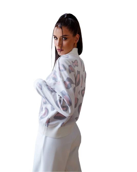Woman wearing a white sweater with abstract pattern on a white background