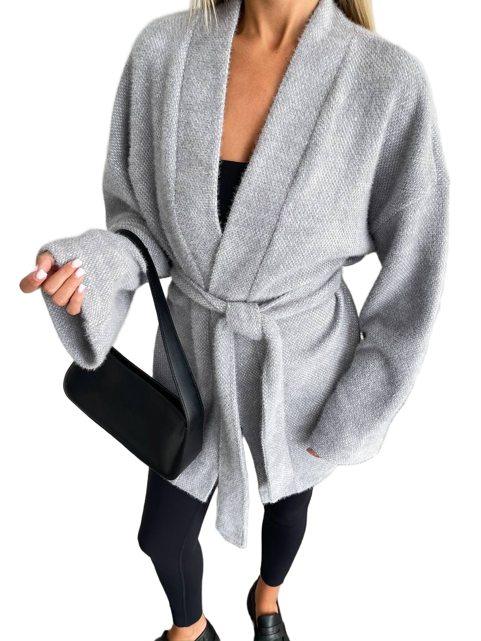 Person wearing a gray robe over black leggings on a white background