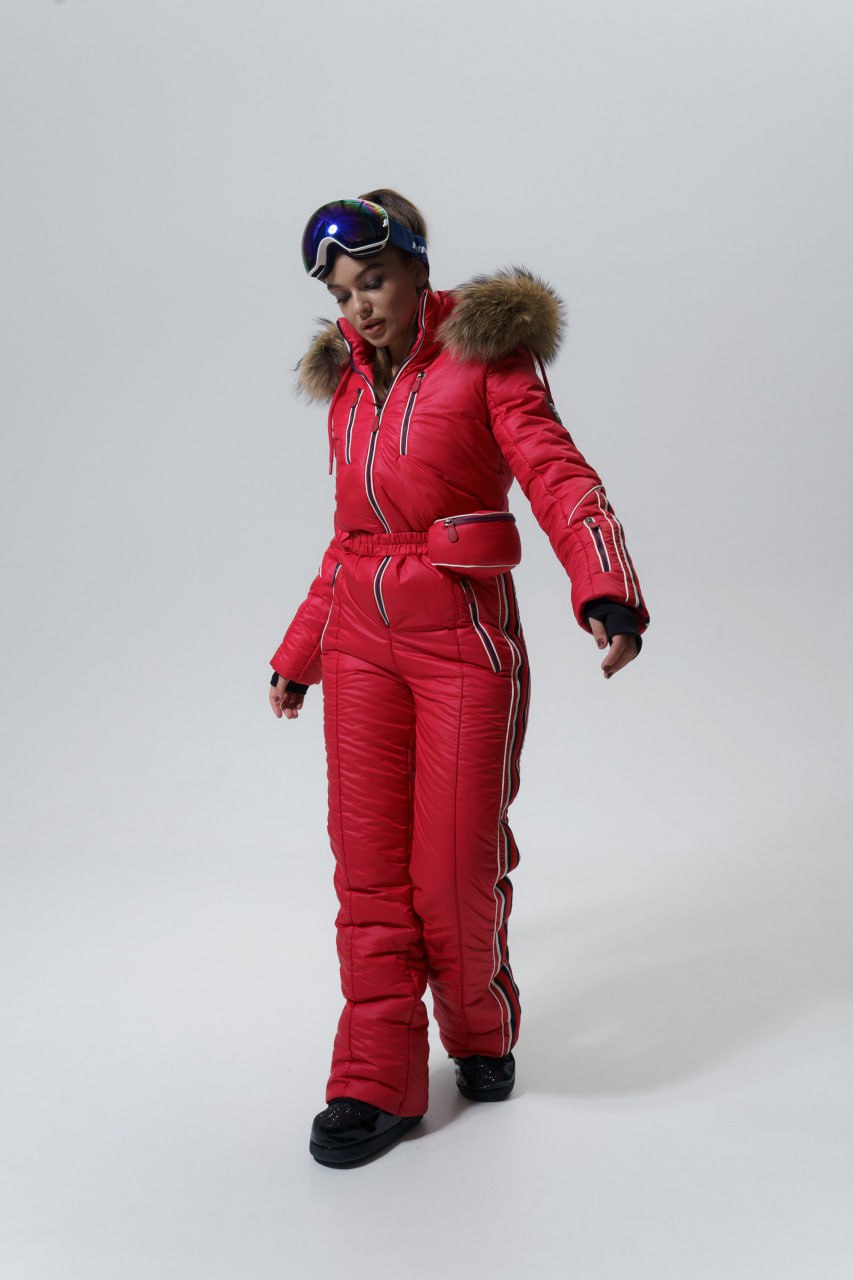 Person wearing a red ski suit with fur trim on a white background