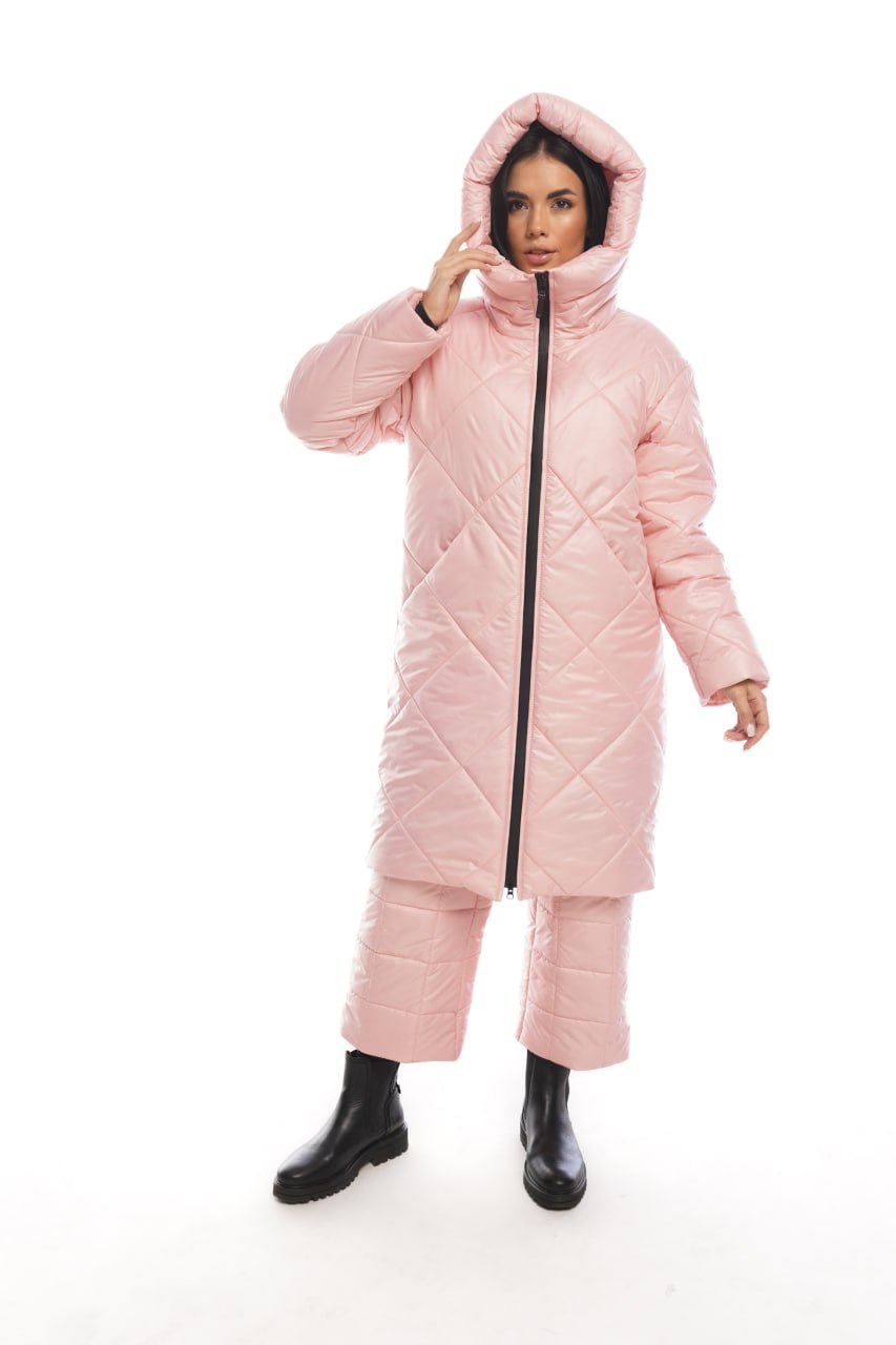 Person wearing a pink quilted jumpsuit on a white background
