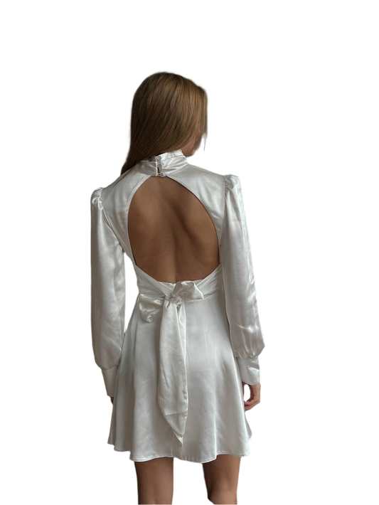 White open-back dress worn by a model on a white background