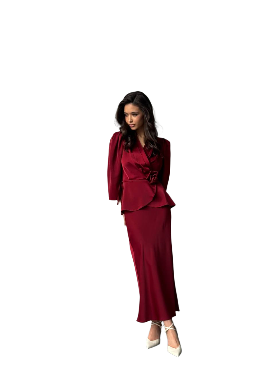 Woman wearing a burgundy suit on a white background