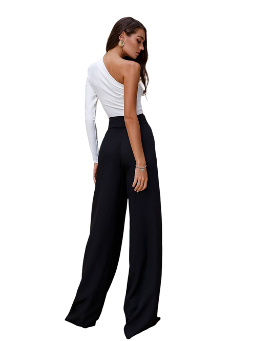 Woman wearing a white one-shoulder top and black wide-leg pants on a white background