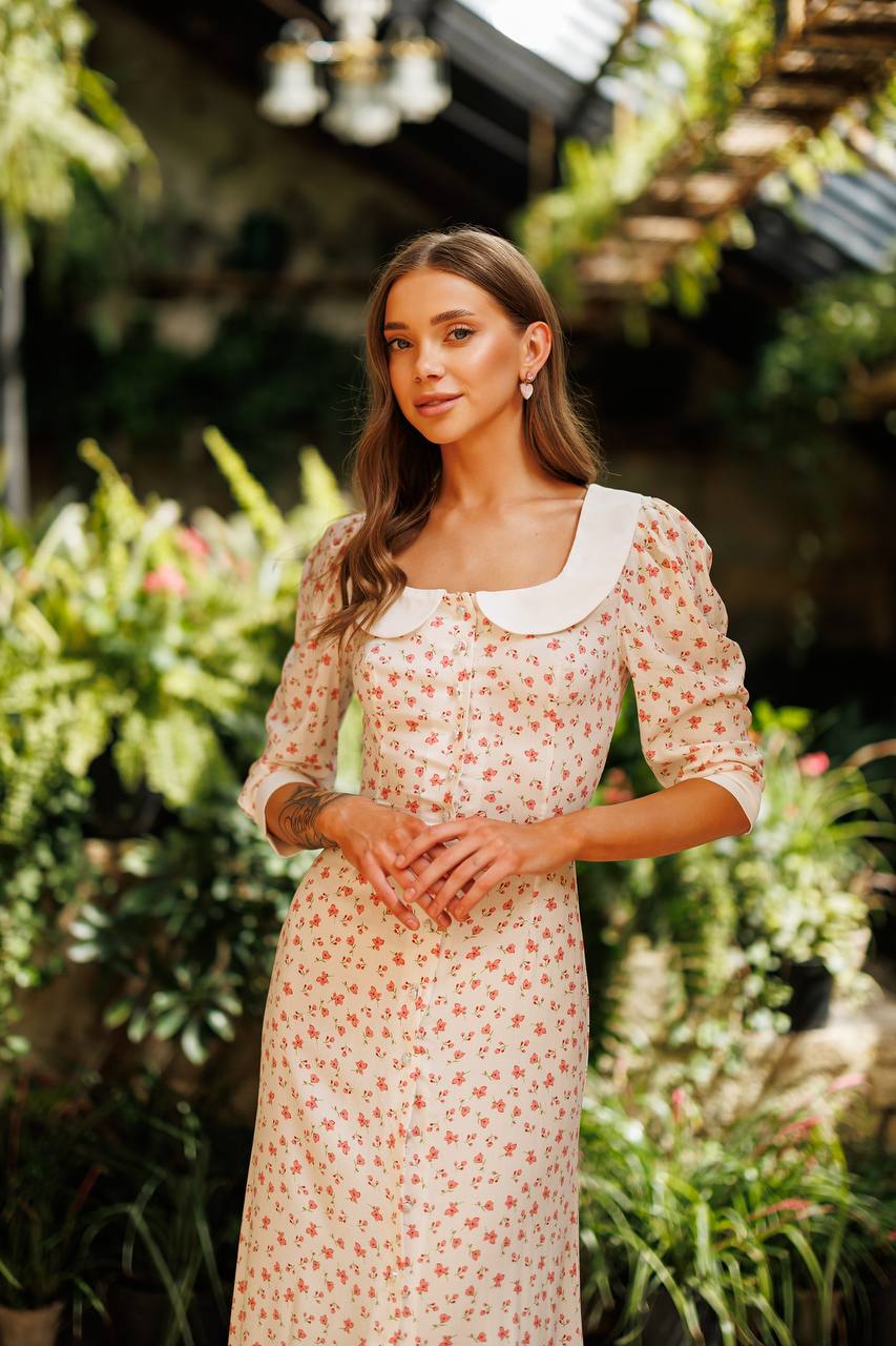 Woman in a floral dress standing in a garden
